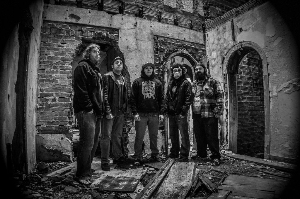 Cassette Tape posing inside the historic, now-demolished Stewart Mansion in Galveston, capturing the raw, edgy vibe that reflects their genre-blending sound and experimental spirit.